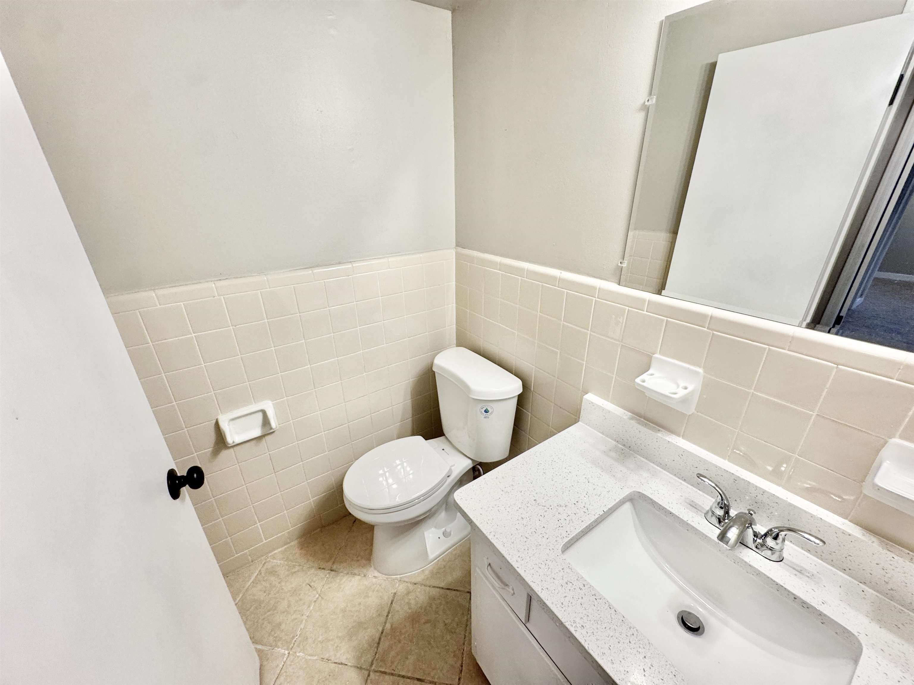 3836 Birchleaf Road Memphis, TN 38116 - Photo 31 of 40 Half bathroom with vanity, tile walls, a wainscoted wall, and light tile patterned floors