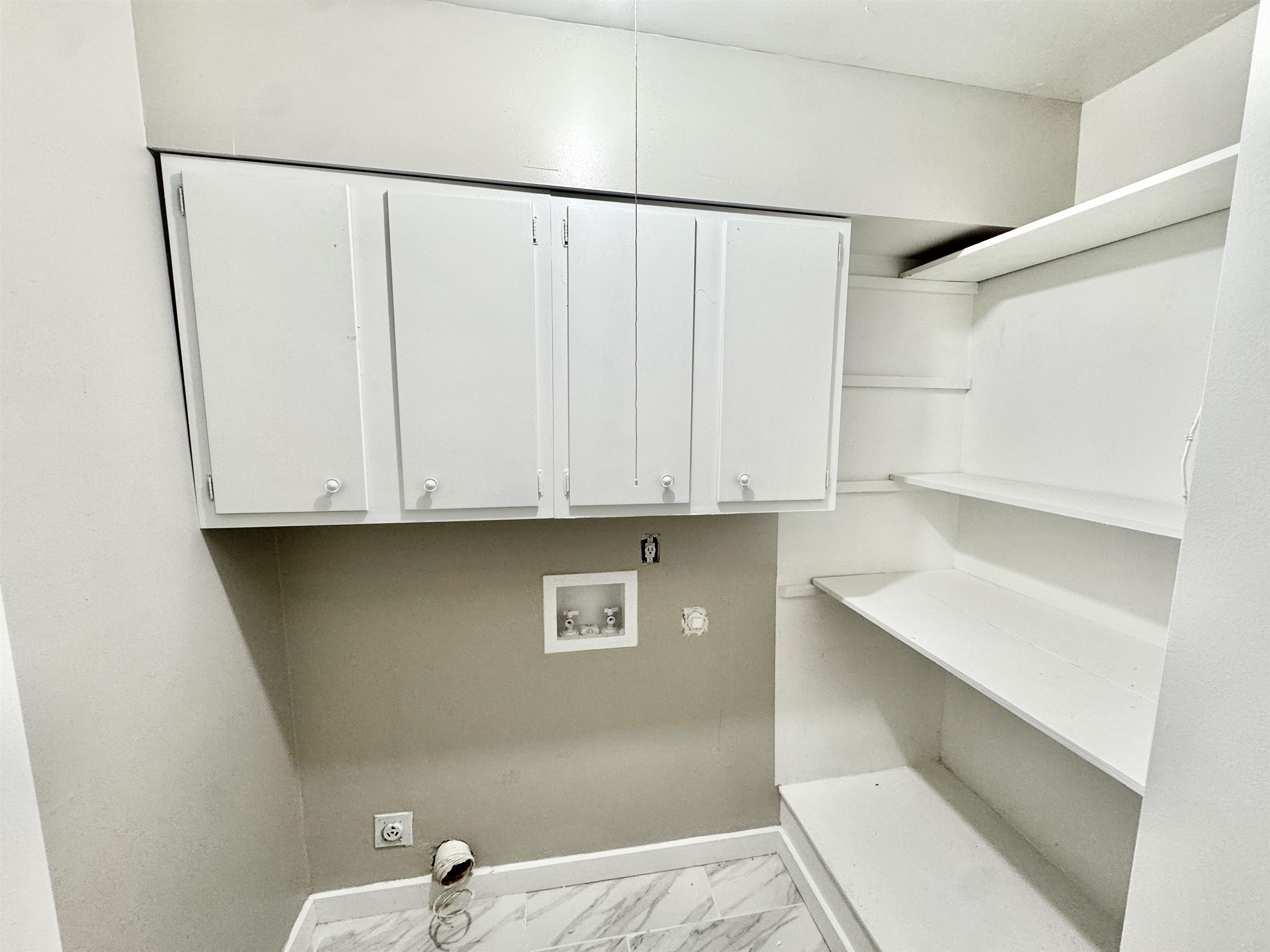 3836 Birchleaf Road Memphis, TN 38116 - Photo 33 of 40 Laundry room with hookup for a washing machine, light marble finish floors, cabinet space, and hookup for an electric dryer