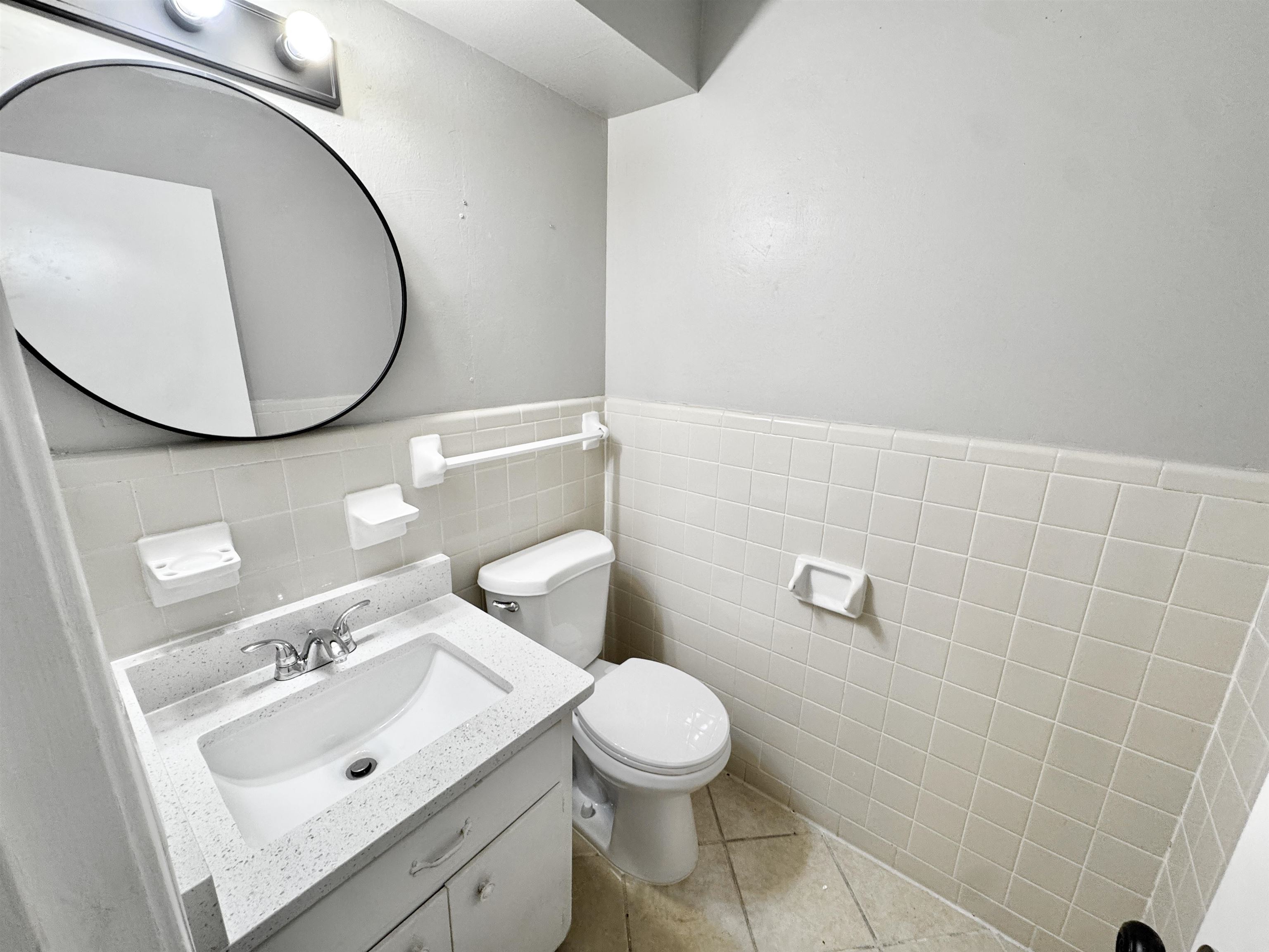 3836 Birchleaf Road Memphis, TN 38116 - Photo 34 of 40 Bathroom with vanity, tile walls, a wainscoted wall, and tile patterned floors