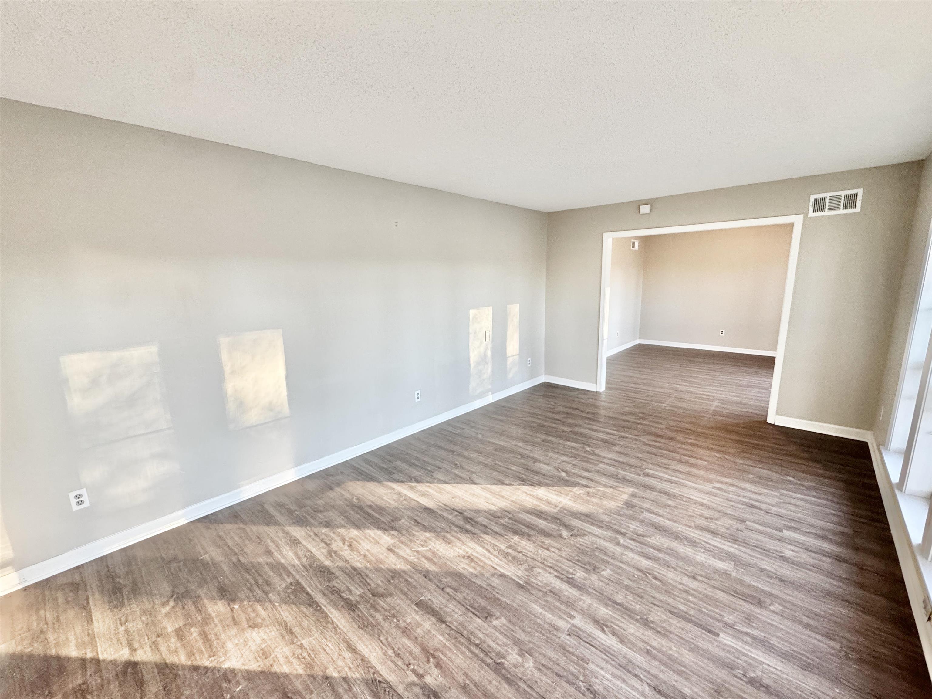 3836 Birchleaf Road Memphis, TN 38116 - Photo 7 of 40 Unfurnished room with a textured ceiling and light wood-style floors