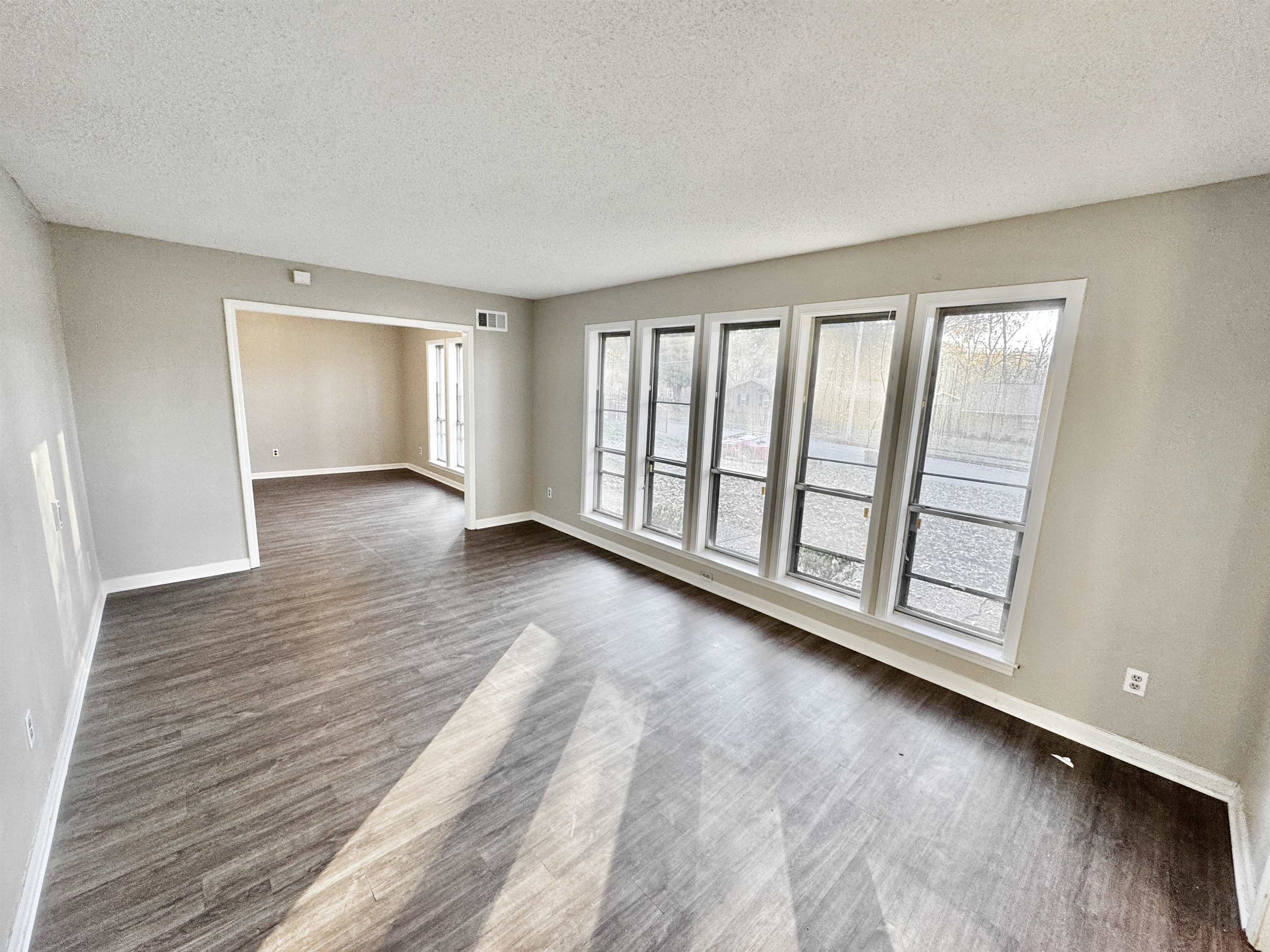 3836 Birchleaf Road Memphis, TN 38116 - Photo 8 of 40 Spare room featuring a textured ceiling and dark wood-style flooring