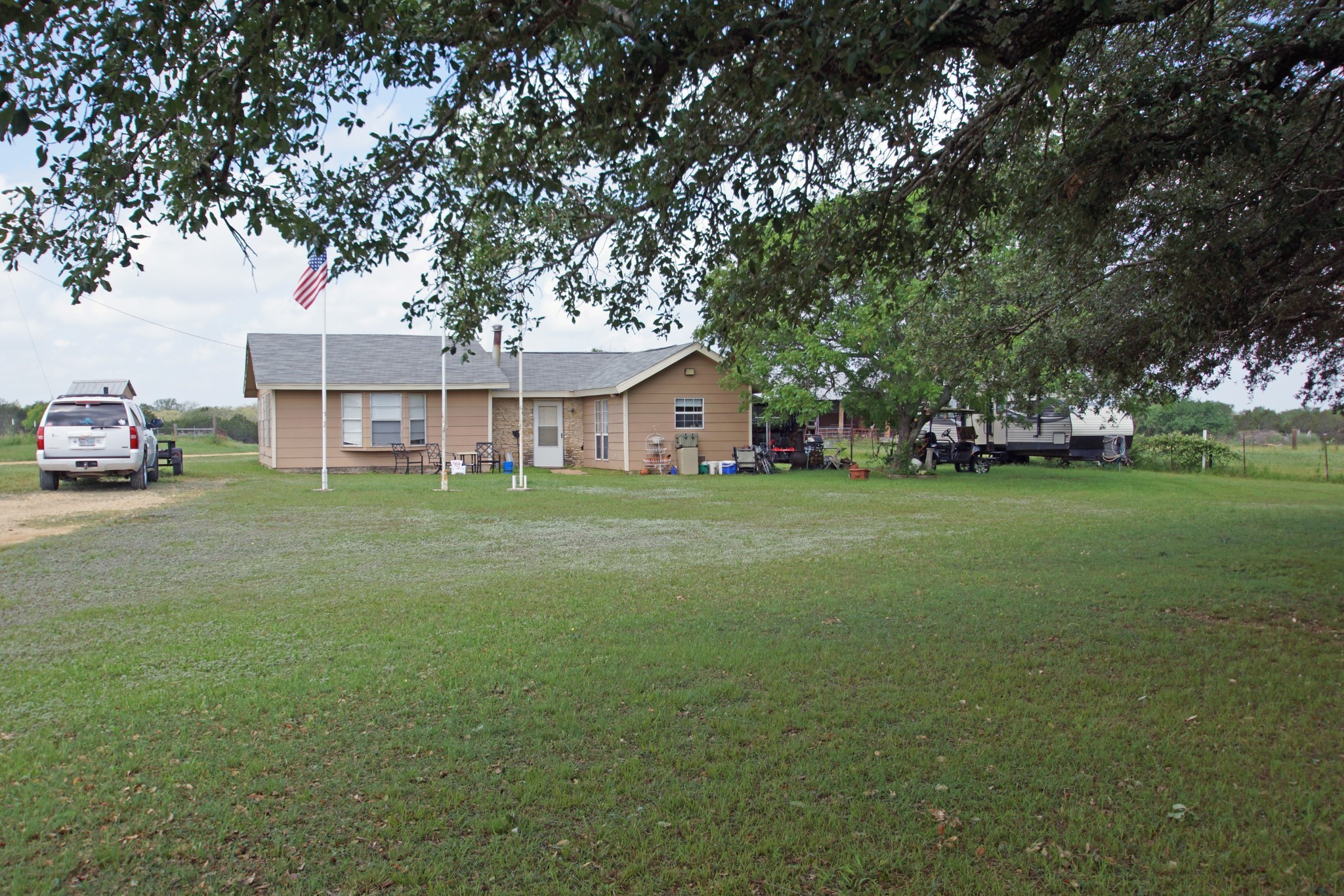 244 Apache Springs Road Briggs, TX 78608 - Photo 4 of 25 a view of a house with a big yard