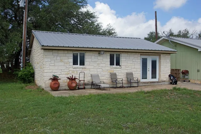 a front view of house with yard and outdoor seating