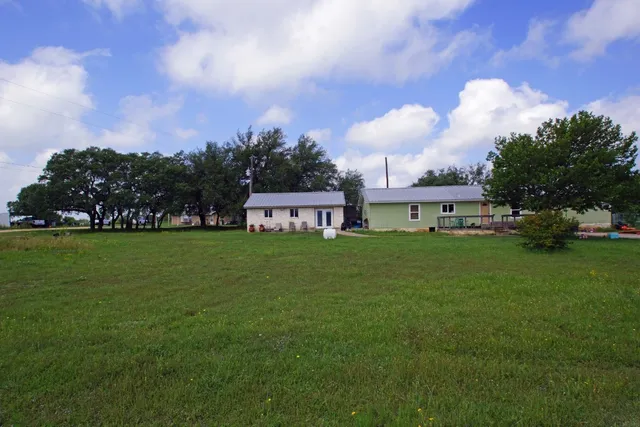 a view of a house with a big yard