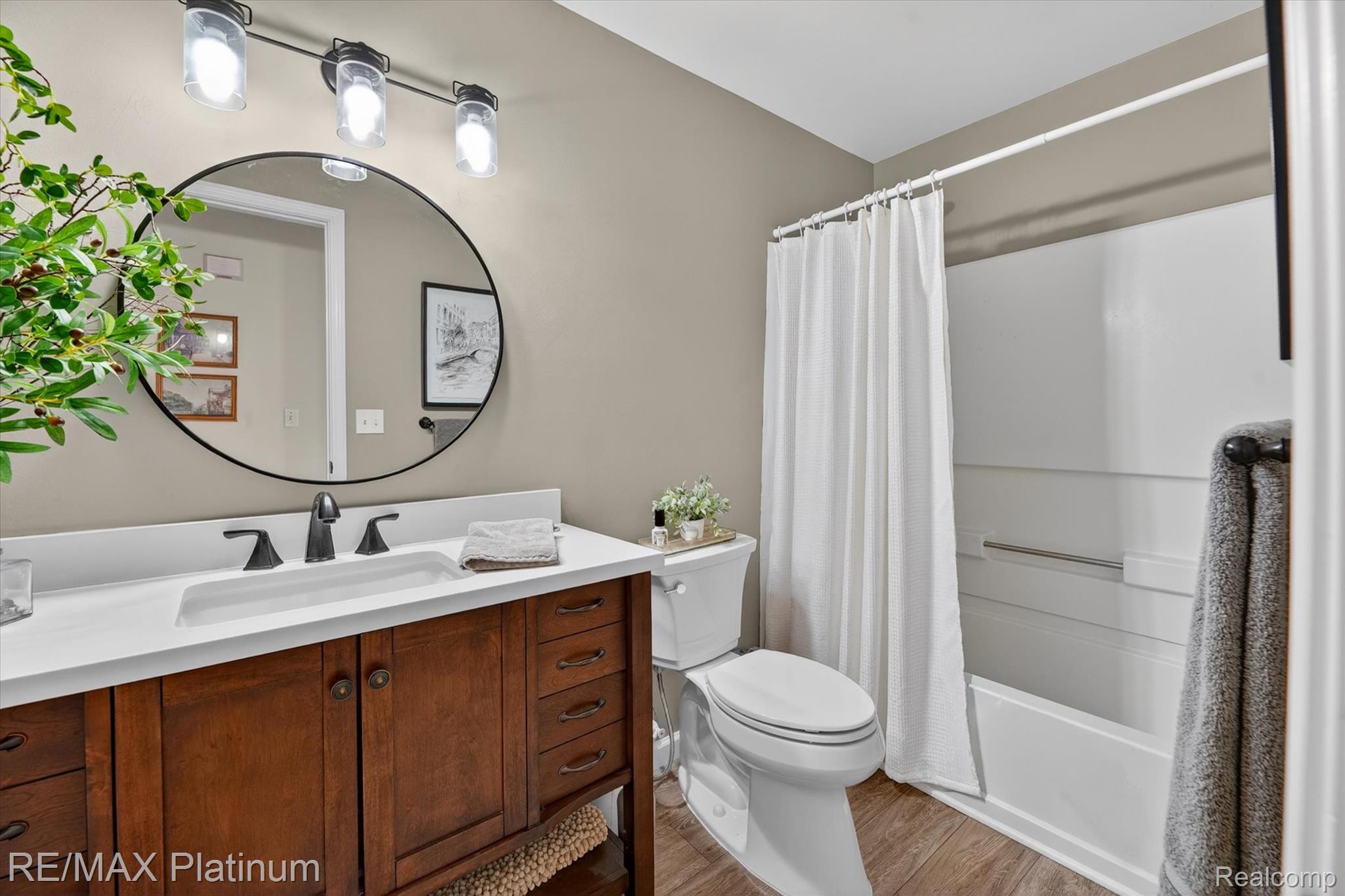 4191 Hampton Ridge Boulevard, Unit 41 Howell, MI 48843 - Photo 15 of 23 Full bath featuring vanity, shower / bath combo with shower curtain, and light wood finished floors