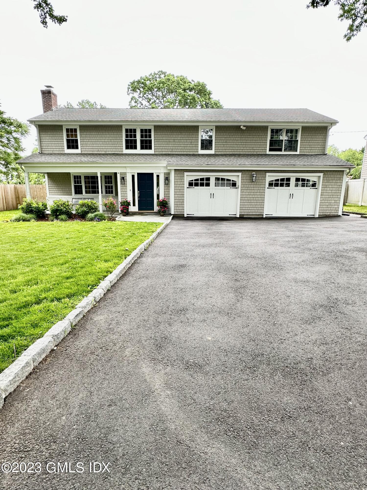 28 Old Orchard Road Riverside, CT 06878 - Photo 1 of 11 a front view of a house with a yard and garage