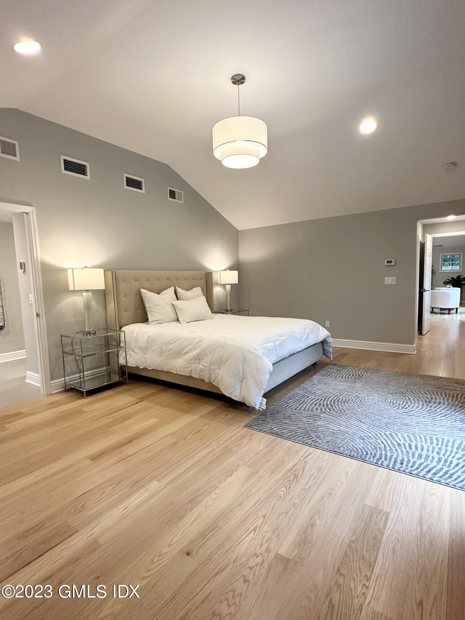 28 Old Orchard Road Riverside, CT 06878 - Photo 6 of 11 a spacious bedroom with a bed and chandelier