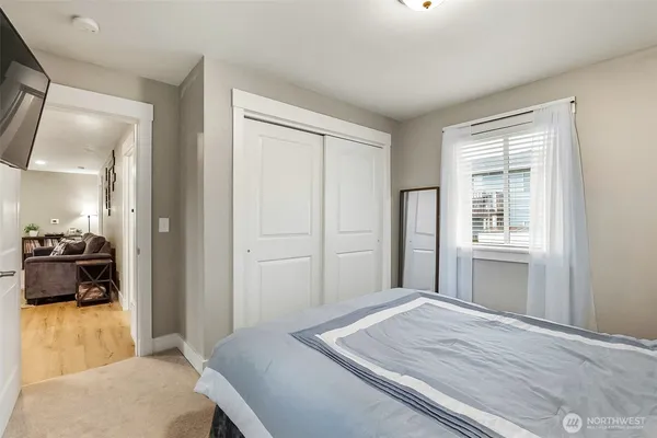 a bedroom with a bed and a large window