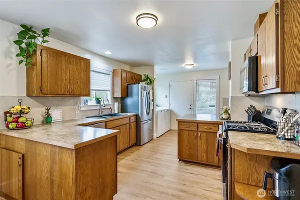 a kitchen with granite countertop a stove sink and cabinets