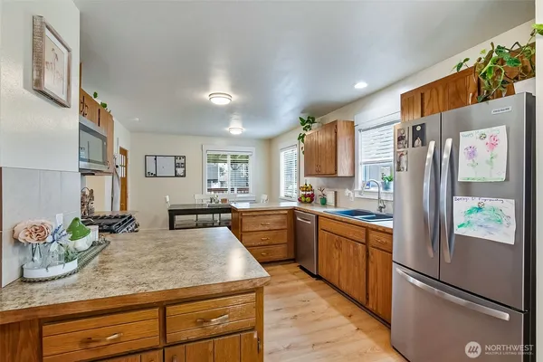 a kitchen with stainless steel appliances granite countertop a refrigerator and a sink