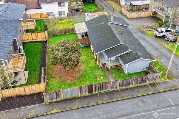 an aerial view of a house with a garden and parking space