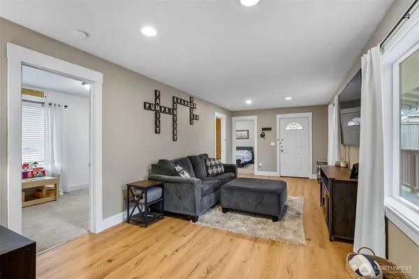 a living room with furniture and wooden floor