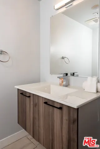 a bathroom with a sink vanity and a mirror