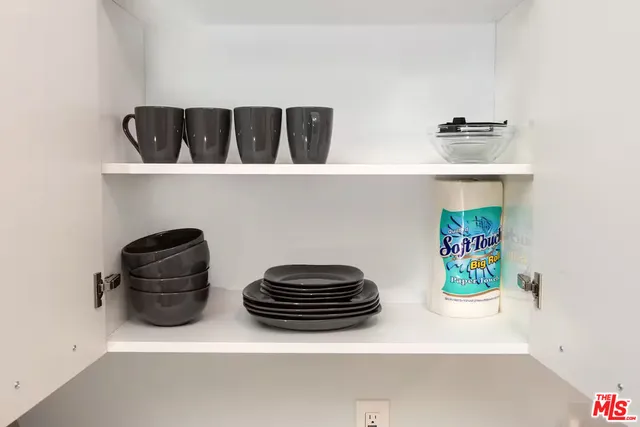 a view of kitchen cabinets with stove and refrigerator