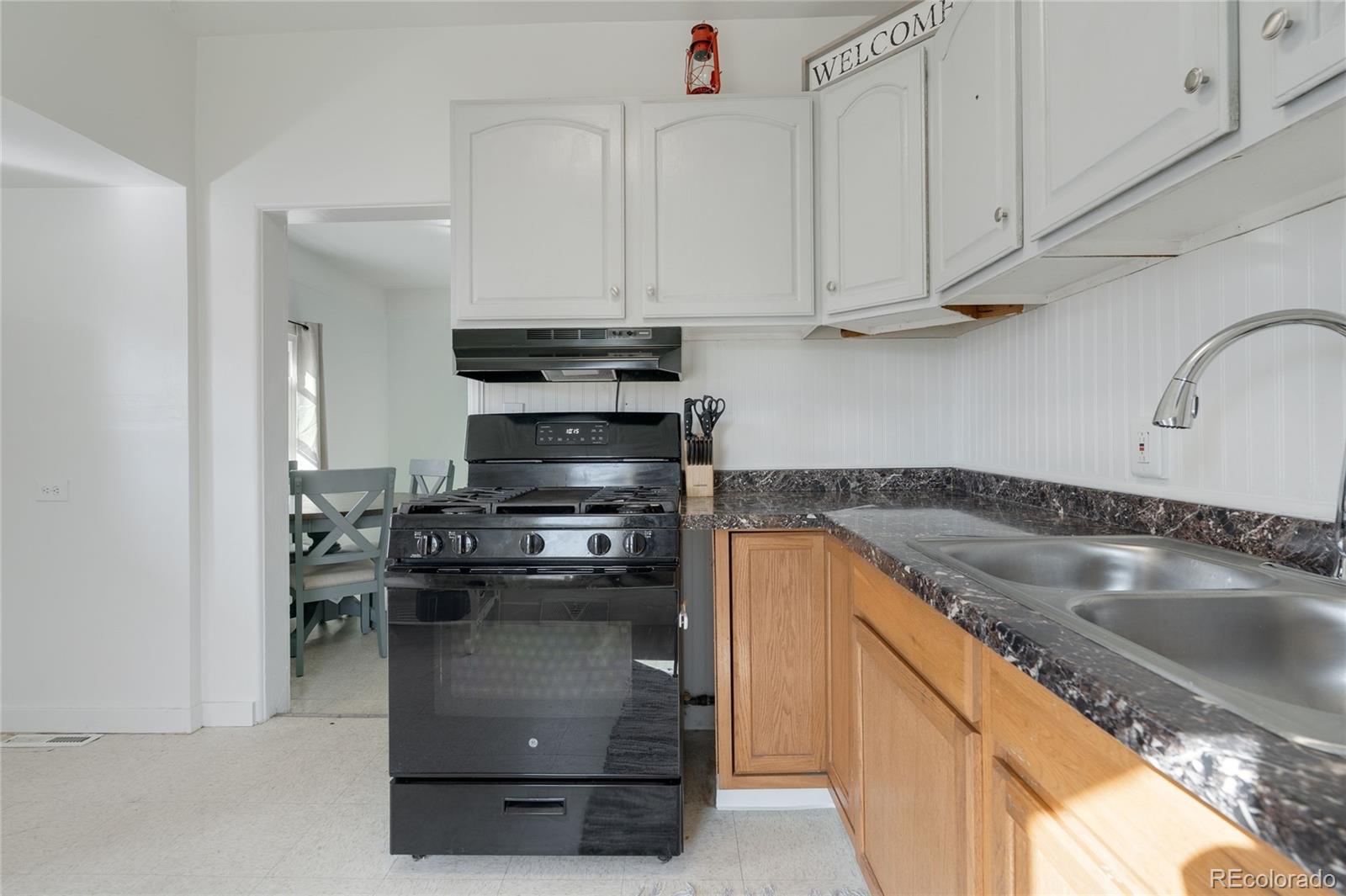 1984 Caroline Avenue Fort Lupton, CO 80621 - Photo 12 of 33 a kitchen with stainless steel appliances granite countertop a sink and a stove