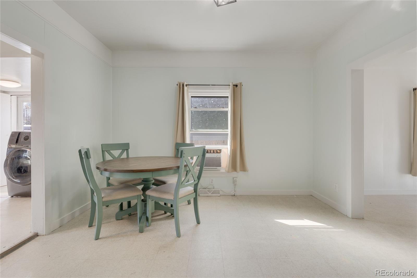1984 Caroline Avenue Fort Lupton, CO 80621 - Photo 15 of 33 a view of a dining room with furniture and a window