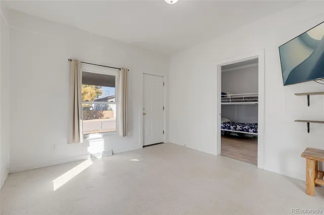 an empty room with windows and closet