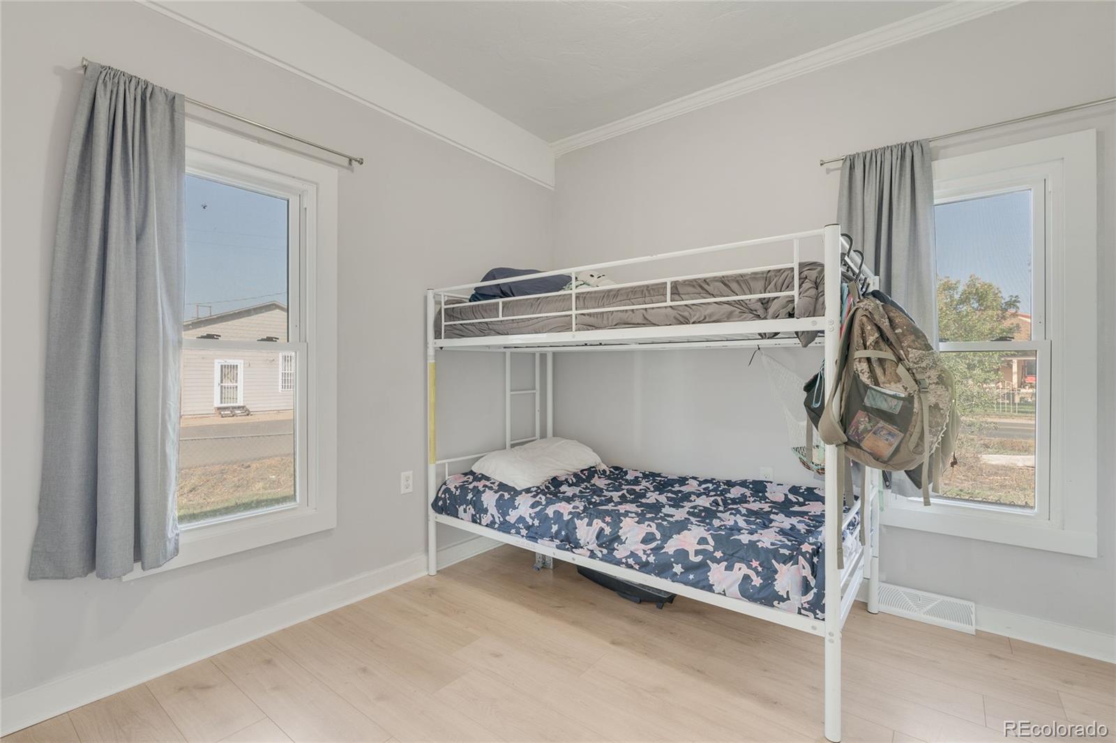 1984 Caroline Avenue Fort Lupton, CO 80621 - Photo 19 of 33 a bedroom with a bed and a window