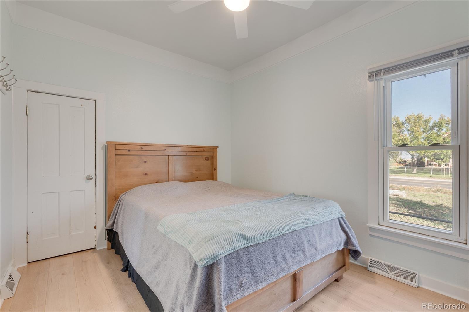 1984 Caroline Avenue Fort Lupton, CO 80621 - Photo 25 of 33 a bedroom with a bed and a window