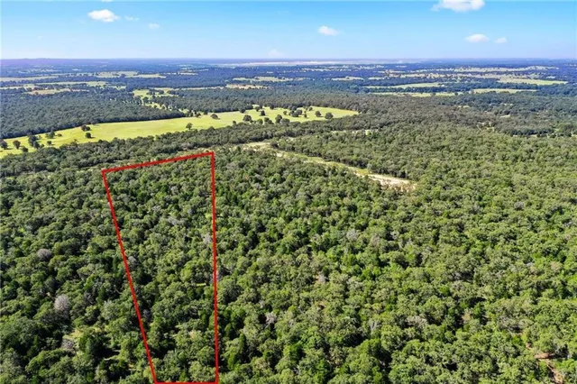 an aerial view of a houses with a yard