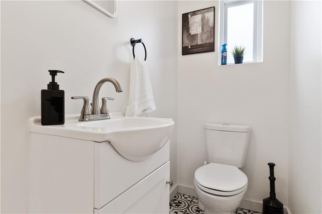 1238 Butterfield Way Pittsburgh, PA 15212 - Photo 14 of 25 a bathroom with a toilet sink and mirror