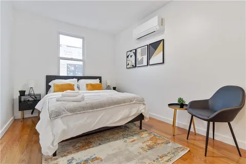 a view of a storage and utility room with washer and dryer
