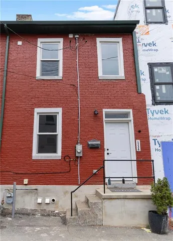 a living room with furniture a dining table and chairs with wooden floor