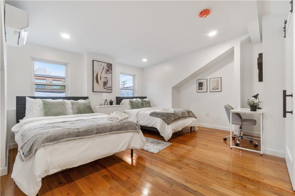 1238 Butterfield Way Pittsburgh, PA 15212 - Photo 22 of 25 a spacious bedroom with a bed a table and chair