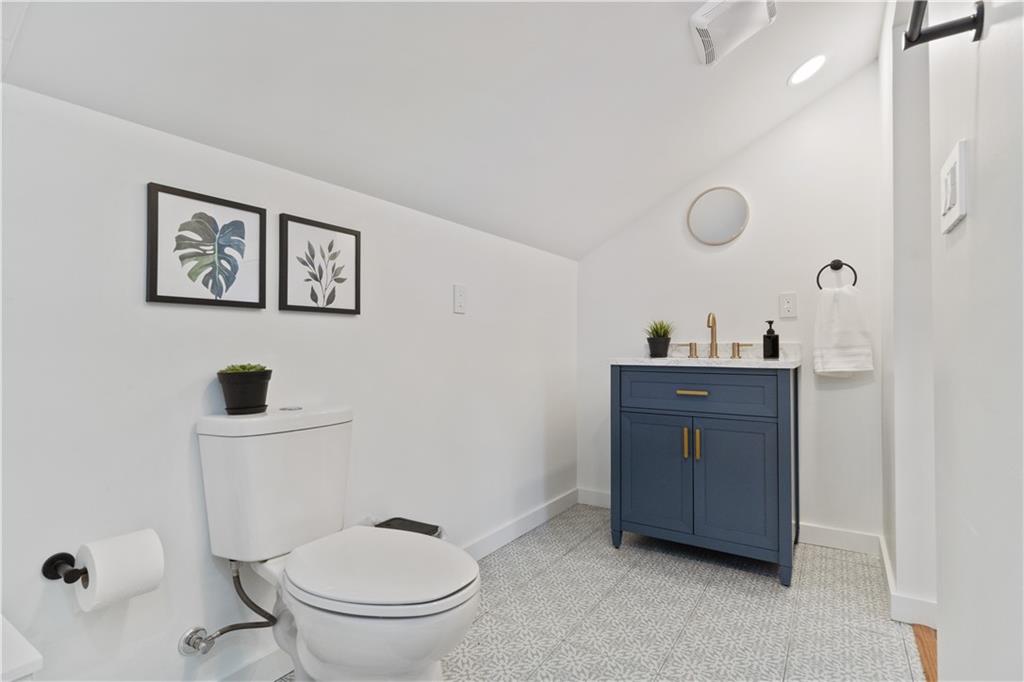 1238 Butterfield Way Pittsburgh, PA 15212 - Photo 23 of 25 a bathroom with a toilet a sink and mirror