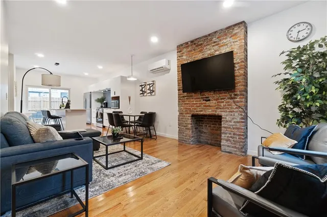a living room with furniture a fireplace and a flat screen tv