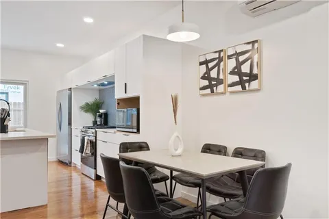 a large kitchen with a table and chairs
