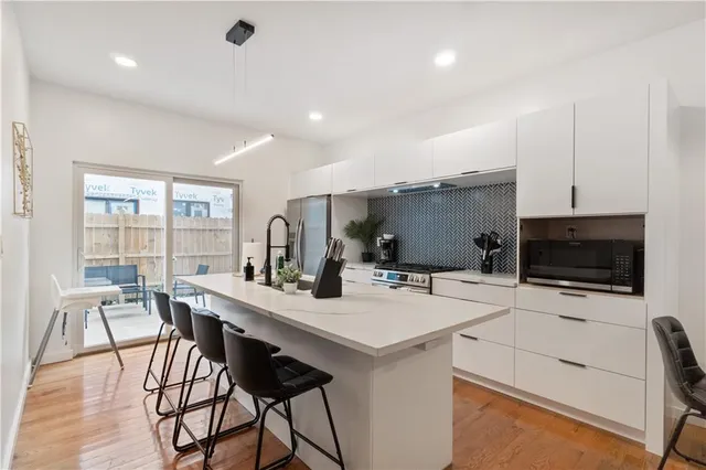 a kitchen with sink a stove and refrigerator