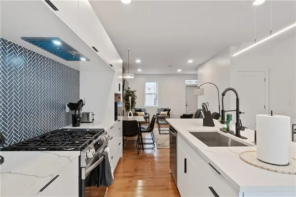 a kitchen with a sink and a stove top oven