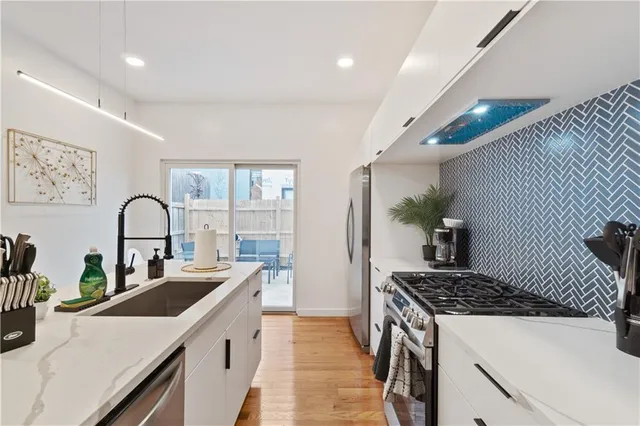 a kitchen with a sink cabinets and wooden floor