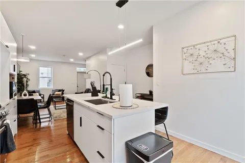 a living room with granite countertop kitchen island with furniture and potted plant