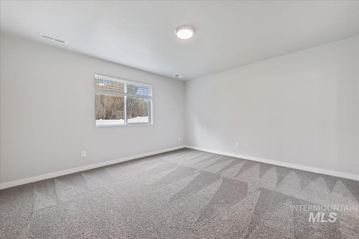 3079 S Green Boise, ID 83709 - Photo 15 of 35 Carpeted spare room featuring baseboards