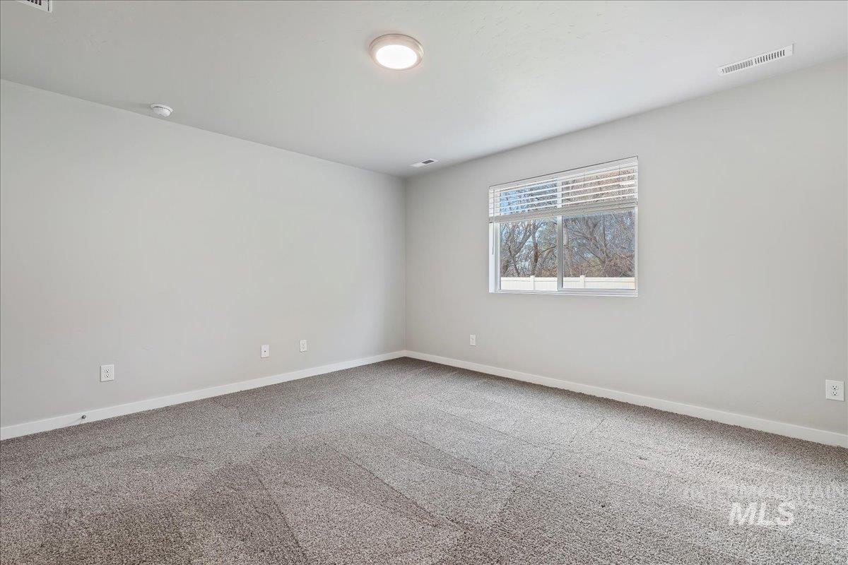 3079 S Green Boise, ID 83709 - Photo 16 of 35 Carpeted spare room featuring baseboards