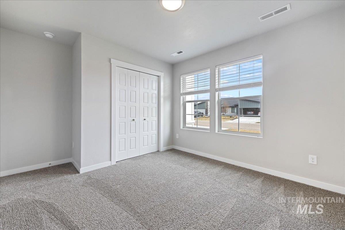 3079 S Green Boise, ID 83709 - Photo 19 of 35 Unfurnished bedroom featuring light colored carpet and a closet