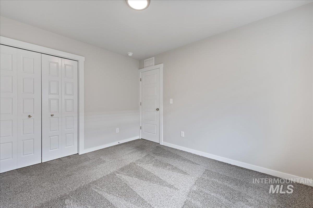 3079 S Green Boise, ID 83709 - Photo 21 of 35 Unfurnished bedroom featuring carpet floors and a closet
