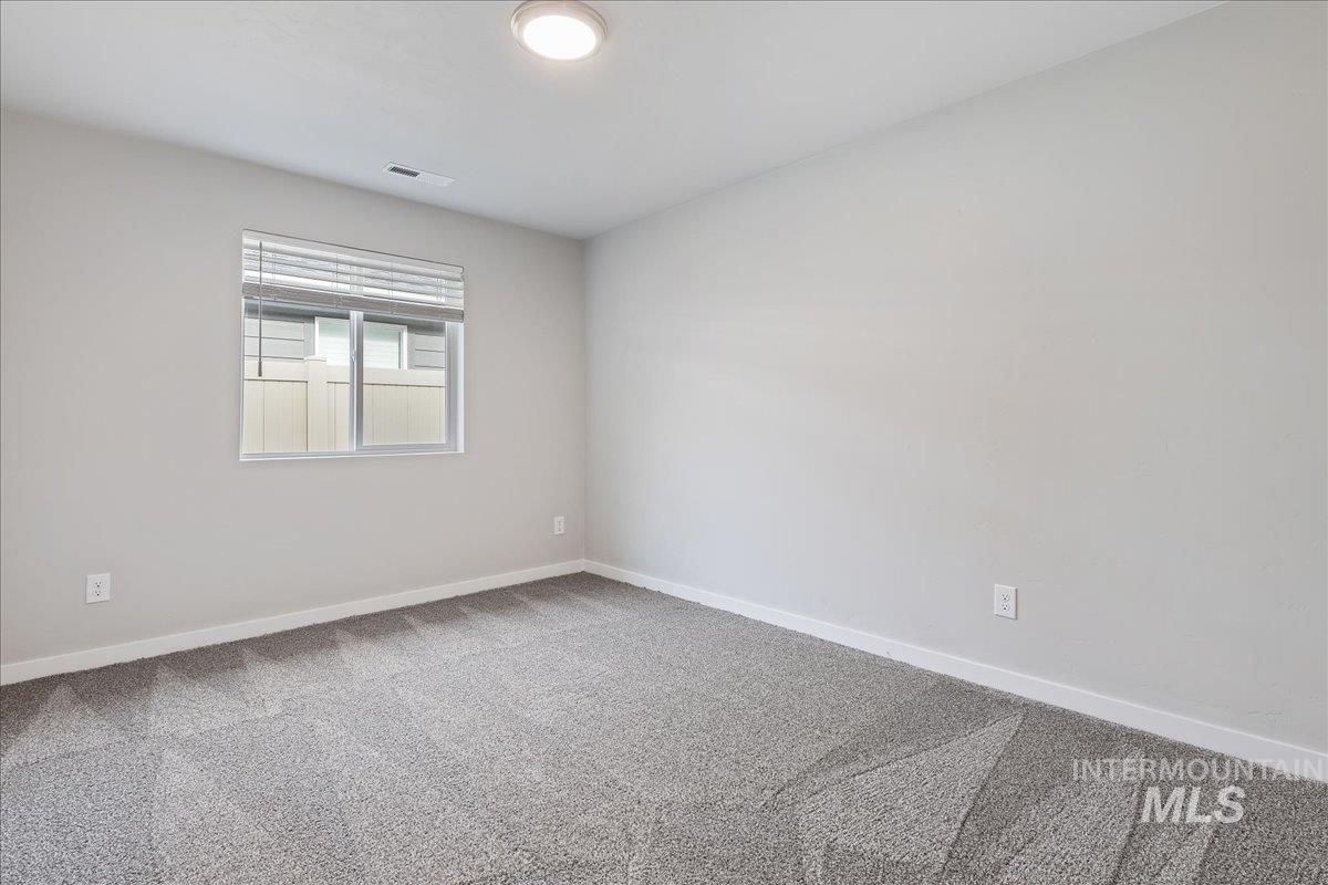 3079 S Green Boise, ID 83709 - Photo 22 of 35 Spare room with light carpet and baseboards