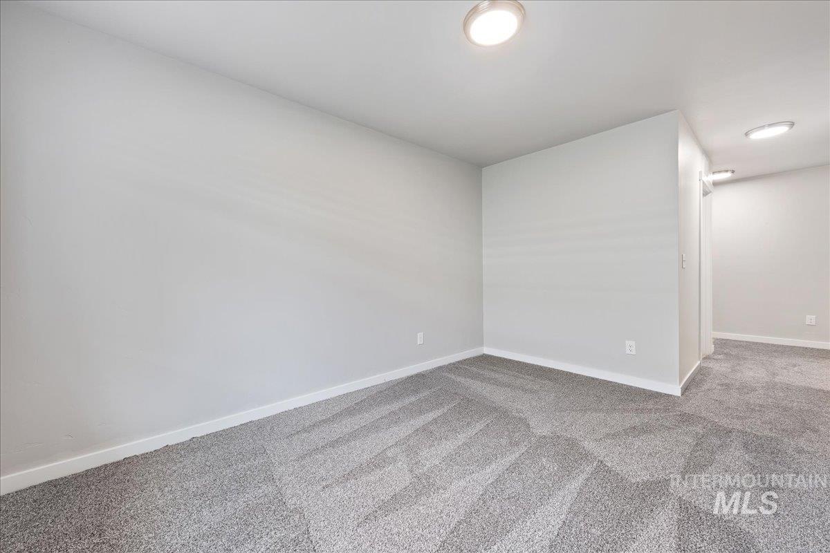 3079 S Green Boise, ID 83709 - Photo 23 of 35 Carpeted spare room featuring baseboards