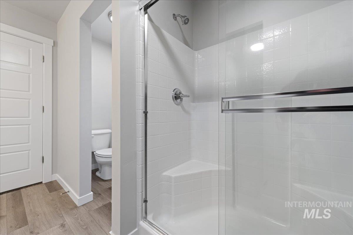 3079 S Green Boise, ID 83709 - Photo 25 of 35 Full bathroom with a stall shower and light wood-style flooring