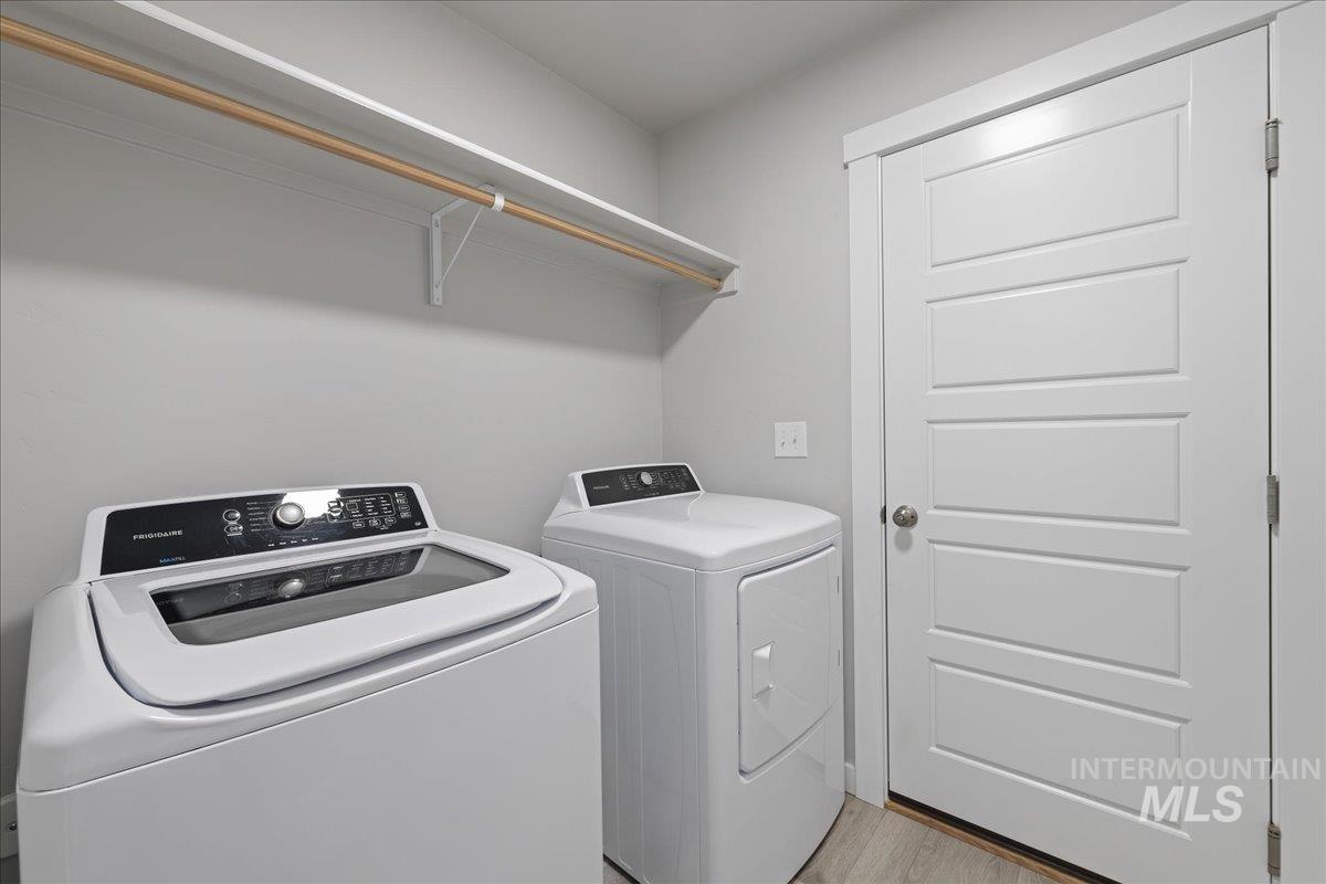 3079 S Green Boise, ID 83709 - Photo 29 of 35 Laundry area with independent washer and dryer and light wood-style flooring