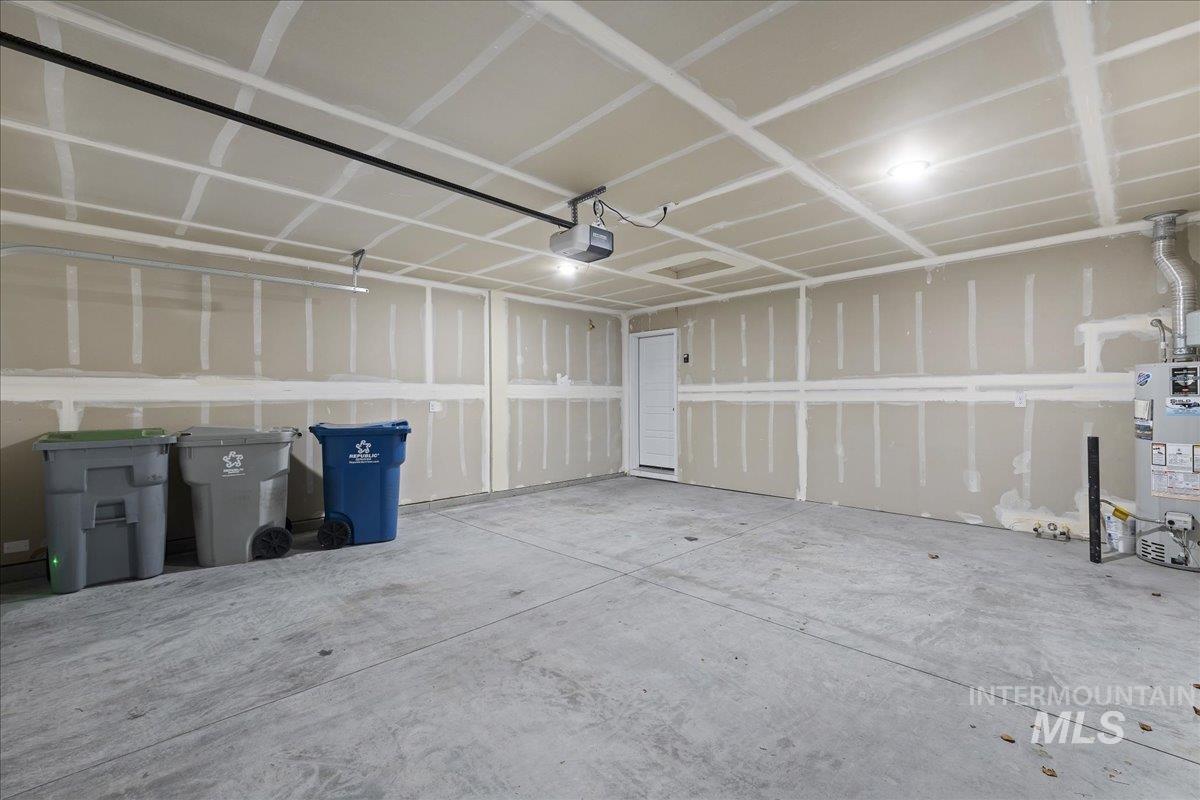 3079 S Green Boise, ID 83709 - Photo 30 of 35 Garage with gas water heater and a garage door opener