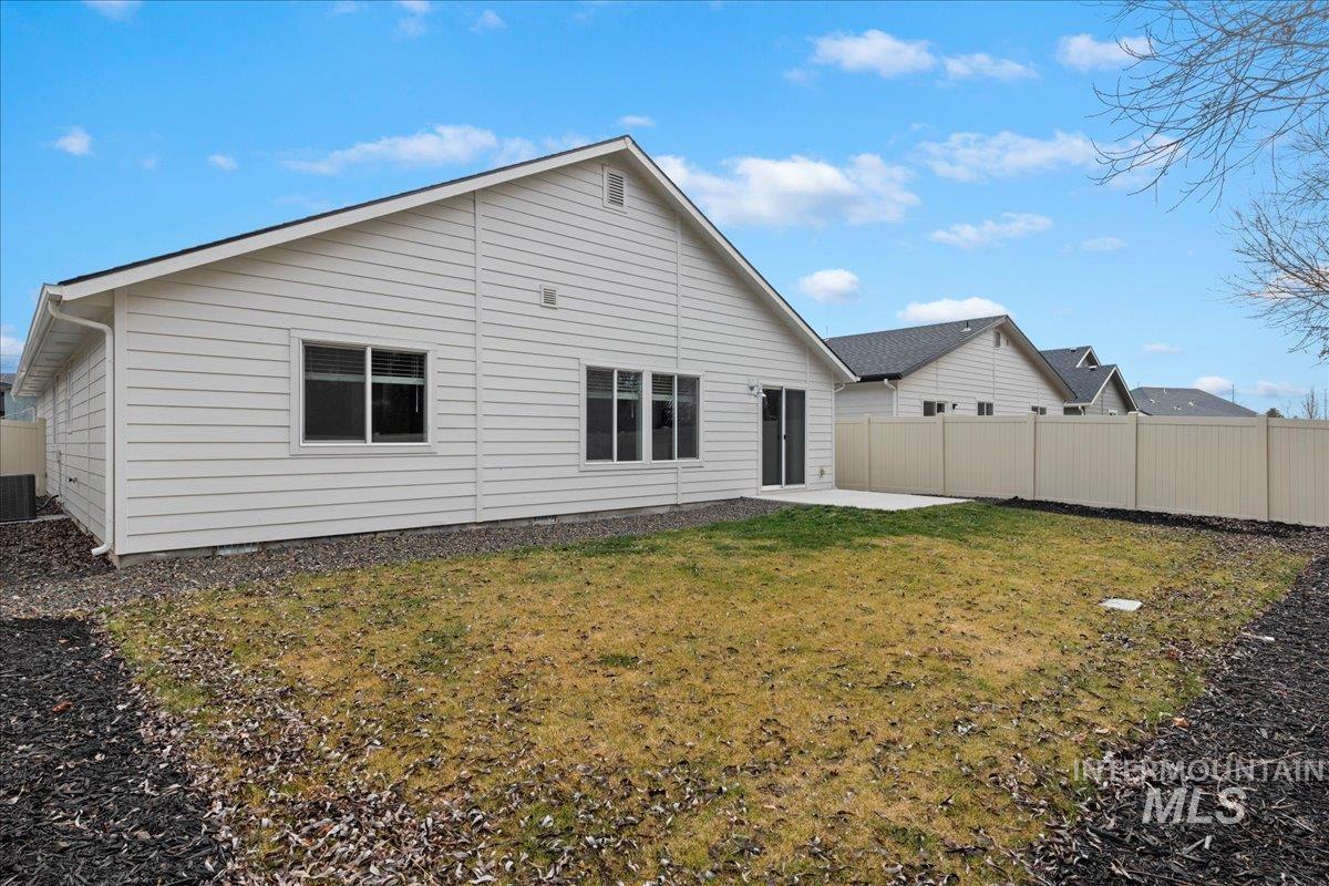 3079 S Green Boise, ID 83709 - Photo 33 of 35 Rear view of property featuring a patio and a fenced backyard