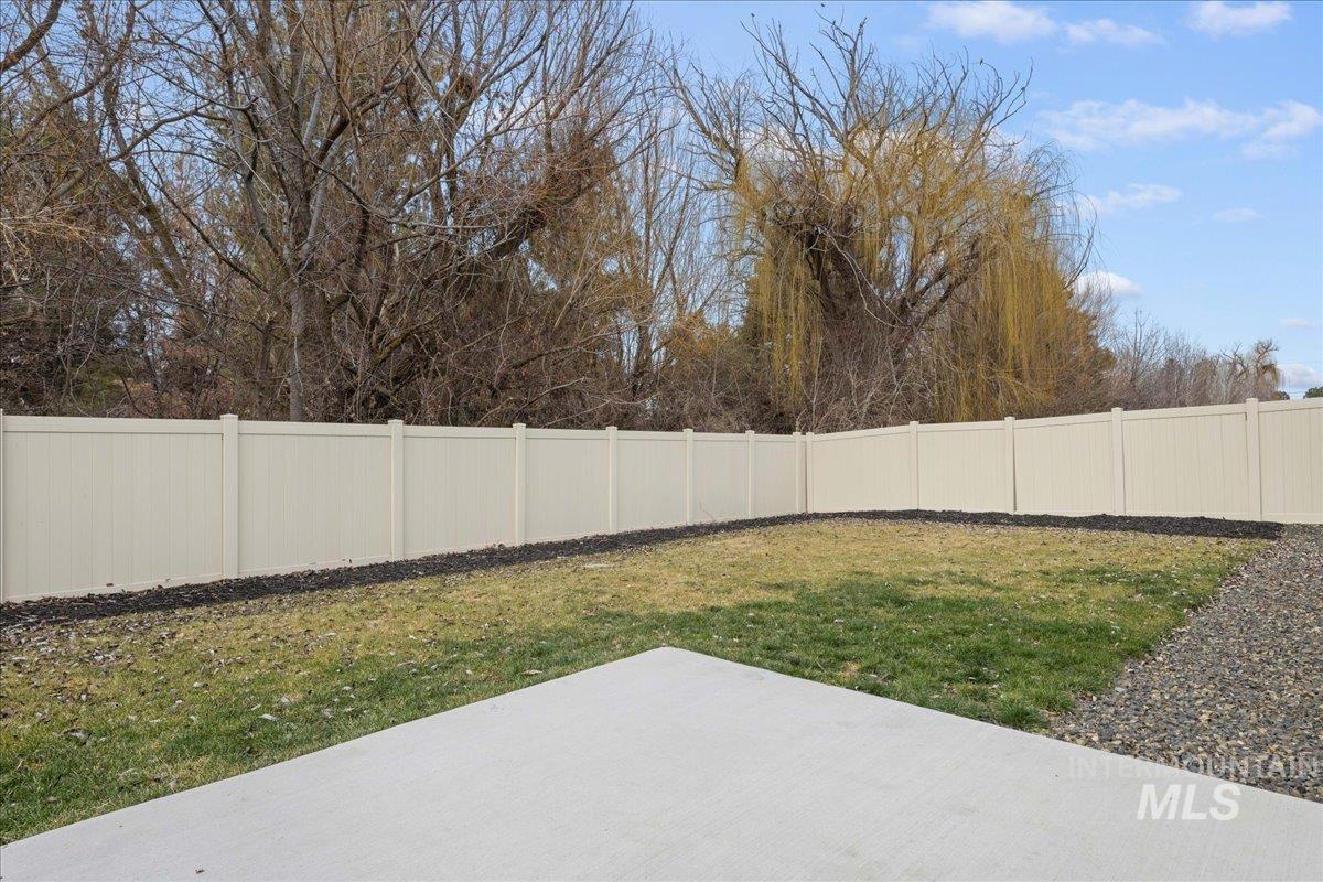 3079 S Green Boise, ID 83709 - Photo 34 of 35 Fenced backyard with a patio area