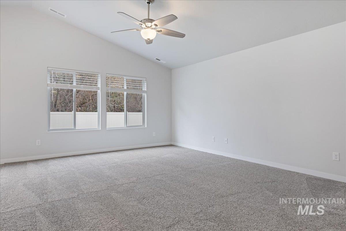 3079 S Green Boise, ID 83709 - Photo 6 of 35 Spare room featuring carpet, ceiling fan, and lofted ceiling