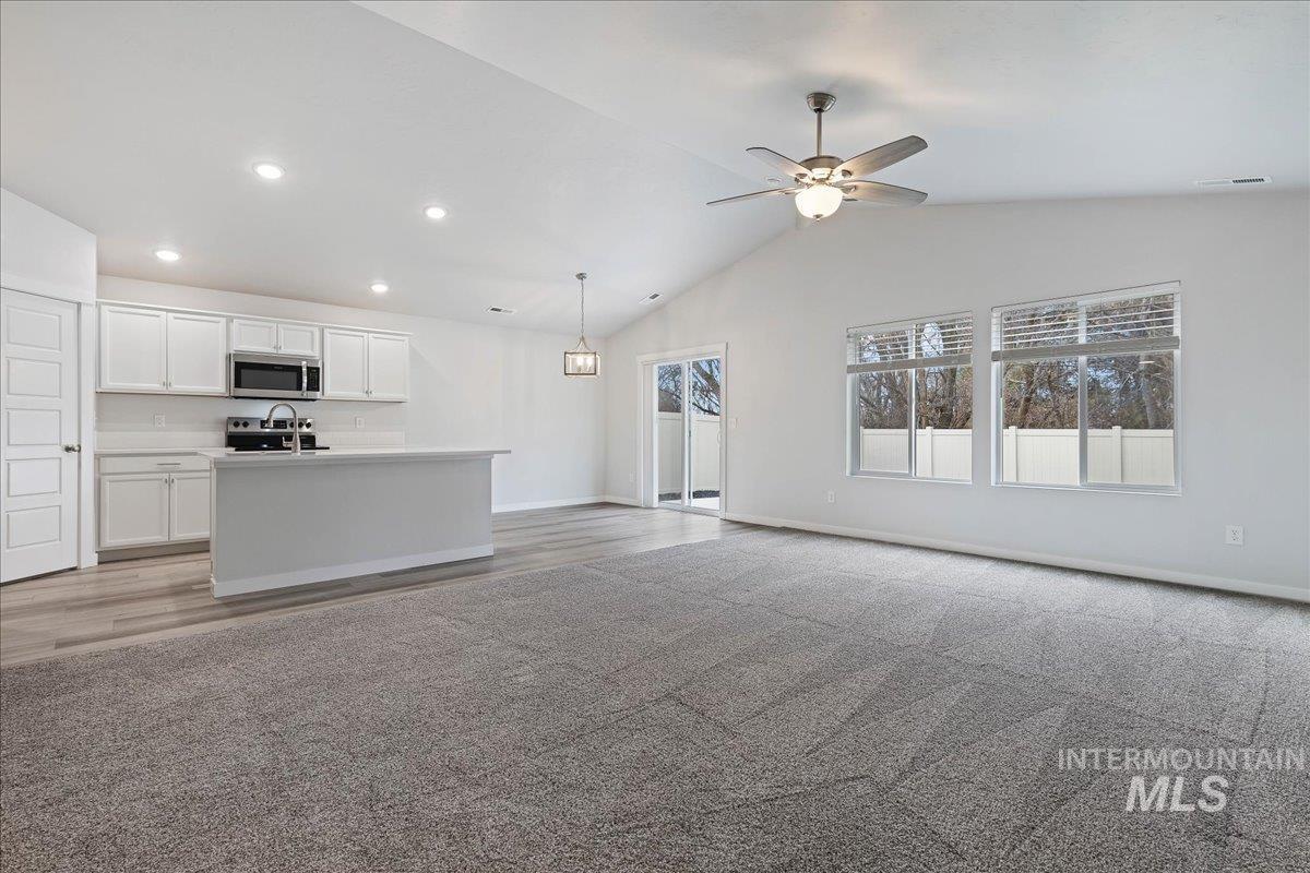 3079 S Green Boise, ID 83709 - Photo 9 of 35 Unfurnished living room with light colored carpet, ceiling fan, and recessed lighting