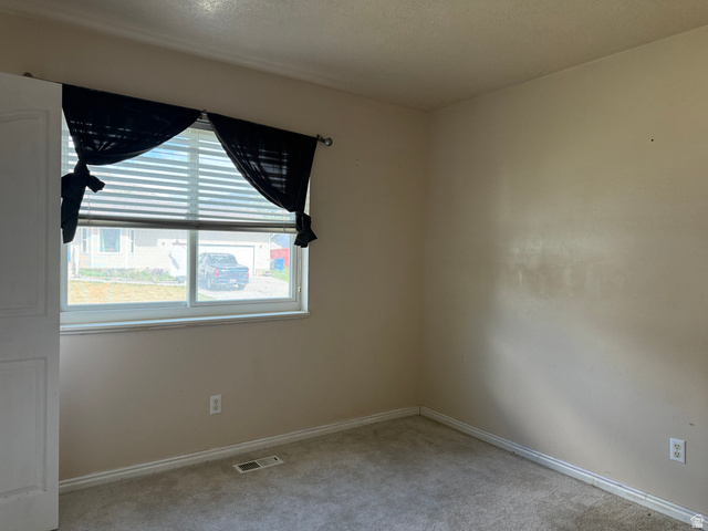 44 Wapiti Loop Hyrum, UT 84319 - Photo 13 of 18 Bedroom featuring a window with horizontal blinds, neutral wall tones, and carpet flooring
