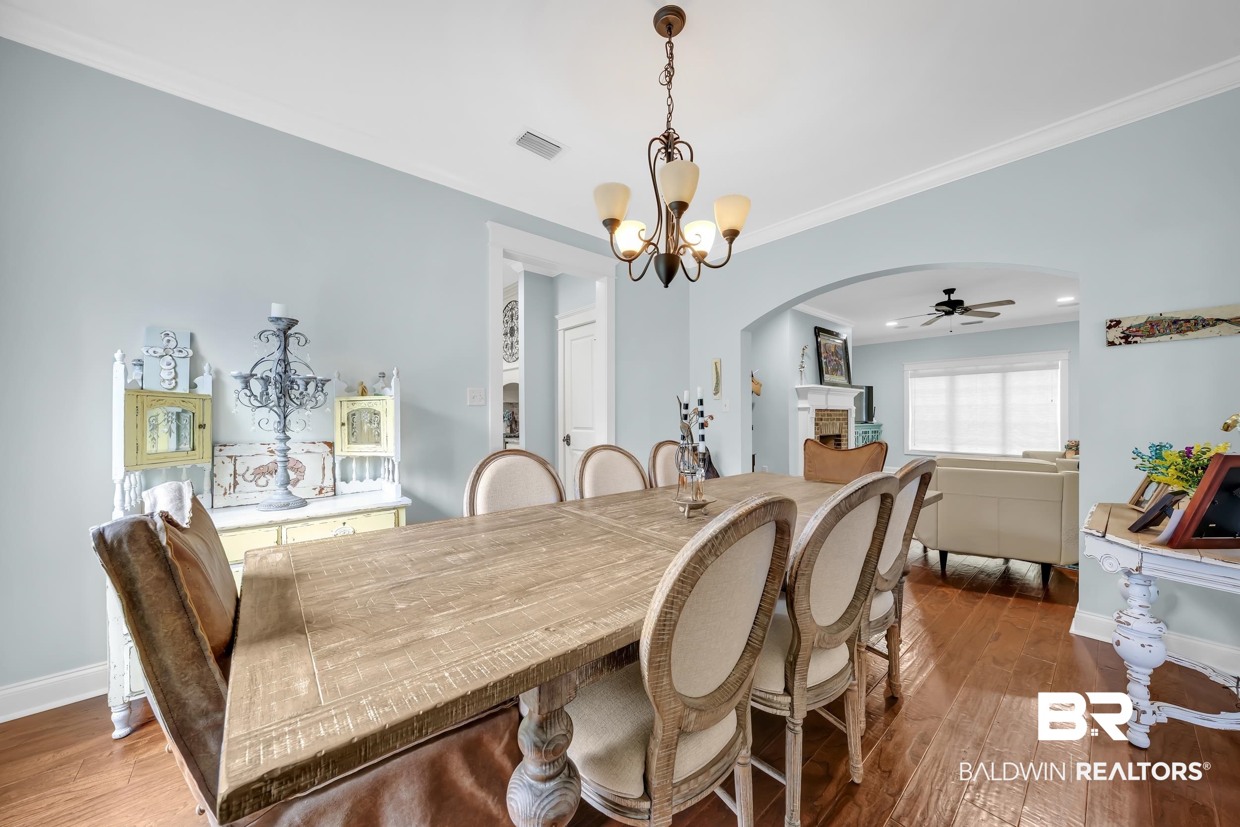 7 Bienville Avenue Mobile, AL 36606 - Photo 10 of 32 Dining space with ornamental molding, arched walkways, hardwood / wood-style floors, a fireplace, and a ceiling fan